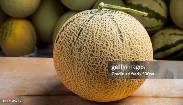 close-up of fruit on table - カンタロープメロン ストックフォトと画像