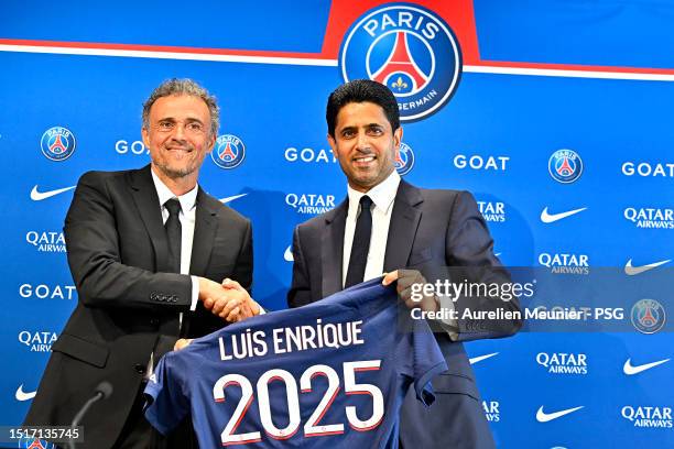 Newly appointed Paris Saint-Germain coach Luis Enrique poses next to PSG President Nasser Al Khelaifi during a press conference at PSG Campus on July...