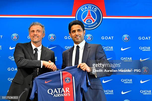 Newly appointed Paris Saint-Germain coach Luis Enrique poses next to PSG President Nasser Al Khelaifi during a press conference at PSG Campus on July...
