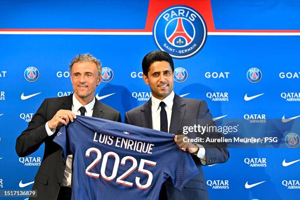 Newly appointed Paris Saint-Germain coach Luis Enrique poses next to PSG President Nasser Al Khelaifi during a press conference at PSG Campus on July...