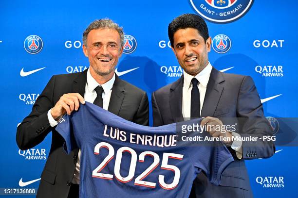 Newly appointed Paris Saint-Germain coach Luis Enrique poses next to PSG President Nasser Al Khelaifi during a press conference at PSG Campus on July...