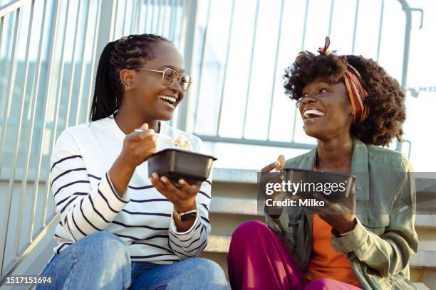 happy female friends on a lunch break - the joys of eating spaghetti stock pictures, royalty-free photos & images