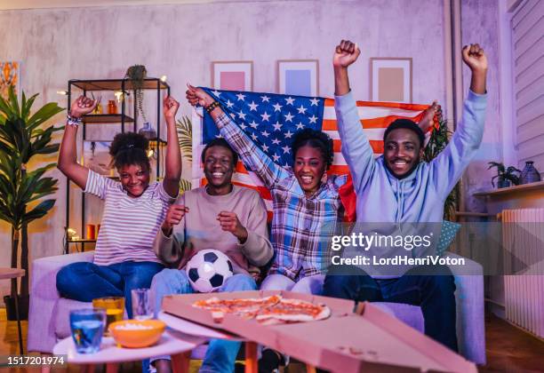 excited american fans watching a soccer match at home - european football championship stock pictures, royalty-free photos & images