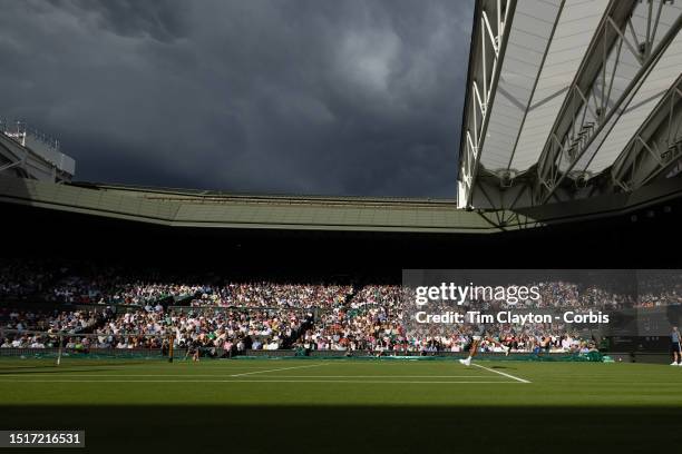 Brief moment of sunshine lights up Centre Court and the gathering clouds on a rain-interrupted day as Novak Djokovic of Serbia plays against Jordan...