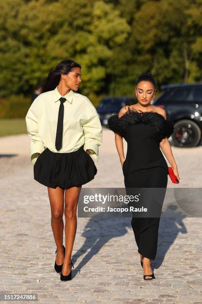 Amina Muaddi and Tina Kunakey attend the Valentino Haute Couture Fall/Winter 2023/2024 show as part of Paris Fashion Week at Chateau de Chantilly on...