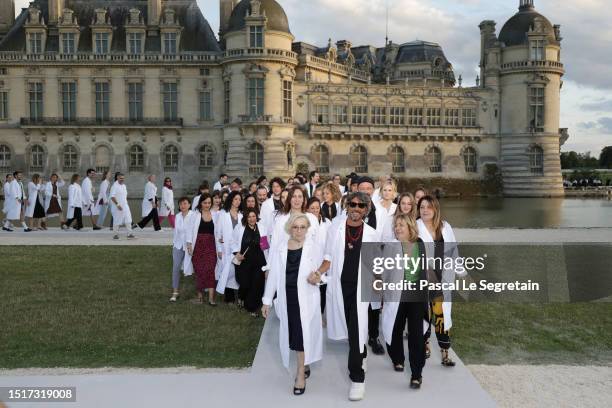 Fashion designer Pierpaolo Piccioli and the Valentino team acknowledge the applause of the audience after the Valentino Haute Couture Fall/Winter...