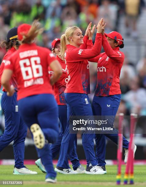 Sarah Glenn of England is congratulated after dismissing Alyssa Healy of Australia during the Women's Ashes 2nd Vitality IT20 match between England...