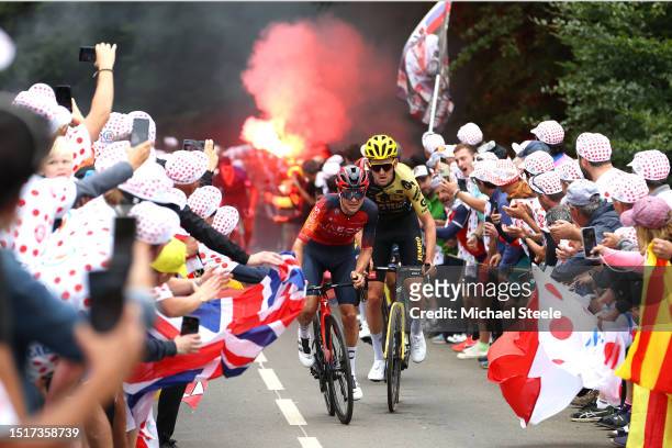 Tom Pidcock of United Kingdom and Team INEOS Grenadiers and Tiesj Benoot of Belgium and Team Jumbo-Visma compete while fans cheers during the stage...