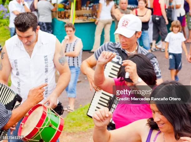 traditional  folk musicians playing accordion and drum, women dancing, azores, portugal. - azores people stock pictures, royalty-free photos & images