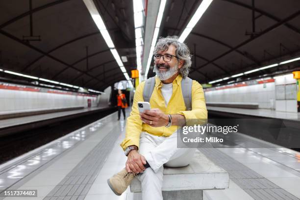 senior man waiting for a train - man phone platform stock pictures, royalty-free photos & images