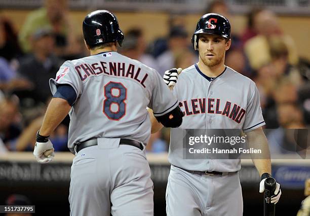 Cord Phelps of the Cleveland Indians congratulates Lonnie Chisenhall on a solo home run against the Minnesota Twins during the seventh inning on...