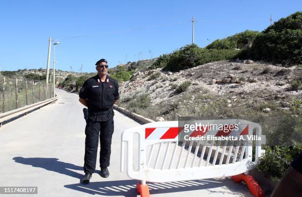Carabiniere stands in front of the access road to the Lampedusa Hotspot on July 04, 2023 in Lampedusa, Italy. The Contrada Imbriacola hotspot of...