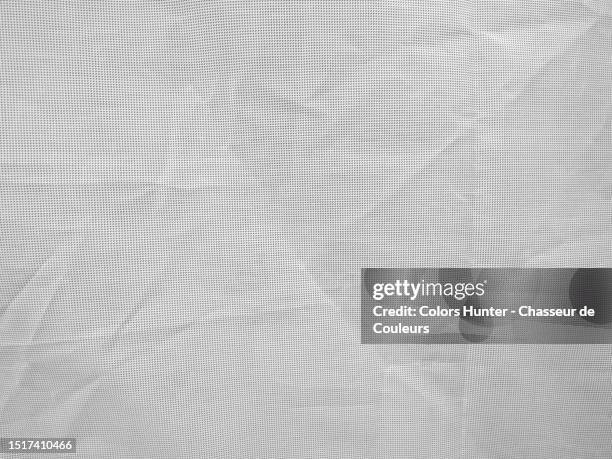 close-up of a white plastic sheet, crumpled and pierced with small regular holes in brussels, belgium - tarpaulin fotografías e imágenes de stock