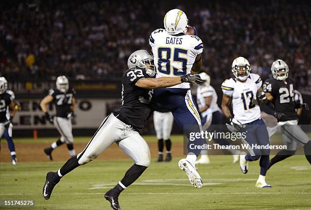 Antonio Gates of the San Diego Chargers catches a seventeen yard pass over Tyvon Branch of the Oakland Raiders in the second quarter of the season...