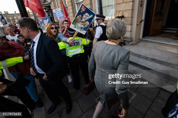 Former Conservative Prime Minister Theresa May arrives as UNITE members and Save Our NHS activists protest outside a Conservative party fundraiser at...