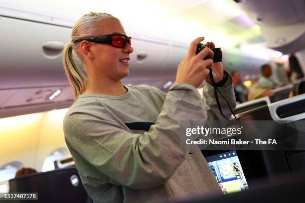 Bethany England of England takes a photo onboard as the Lionesses depart for the FIFA Women's World Cup at Heathrow Airport on July 05, 2023 in...