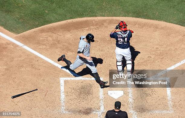 Miami Marlins center fielder Bryan Petersen crosses home plate after scoring on a double by Miami Marlins center fielder Justin Ruggiano in the...