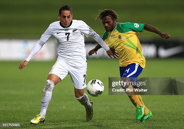 Leo Bertos of New Zealand and Joses Nawo of the Solomon Islands contest the ball during the FIFA World Cup Qualifier match between the New Zealand...