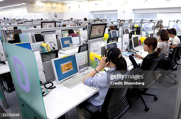 Telephone operators work in Jupiter Shop Channel Co.'s call center in Tokyo, Japan, on Tuesday, Sept. 11, 2012. The TV shop venture which Sumitomo...