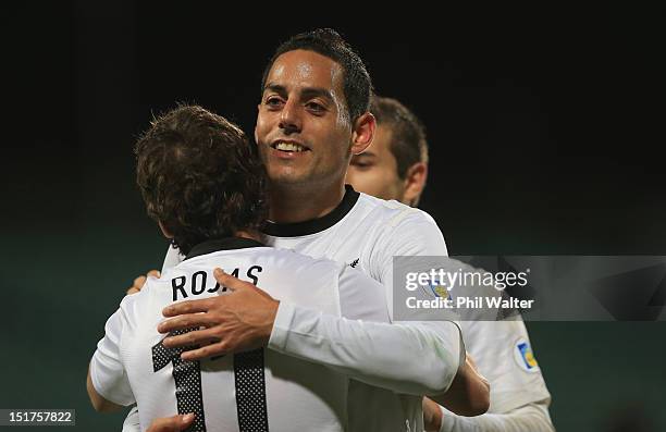 Leo Bertos of New Zealand congratulates Marco Rojas on his goal during the FIFA World Cup Qualifier match between the New Zealand All Whites and...