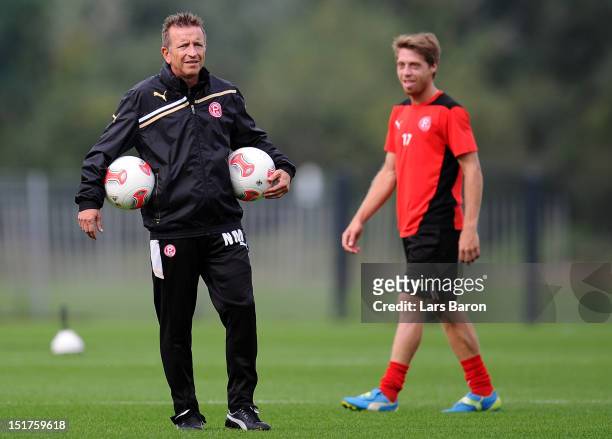 Head coach Norbert Meier looks on next to Andreas Lambertz during a Fortuna Duesseldorf training session on September 11, 2012 in Duesseldorf,...