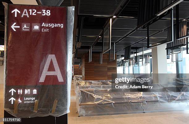 Gate's chairs and an information sign sit wrapped in plastic on the construction site of the new Willy Brandt Berlin Brandenburg International...