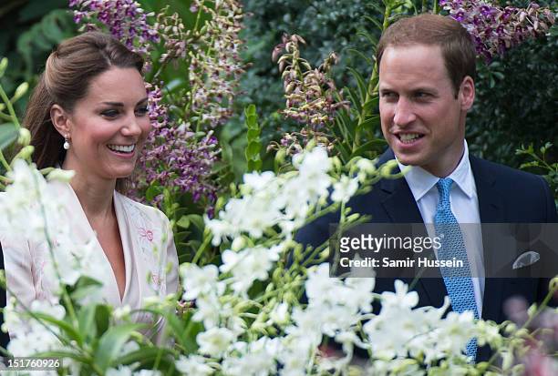 Catherine, Duchess of Cambridge and Prince William, Duke of Cambridge look on at an orchid named in honour of Diana, Princess of Wales at Singapore...