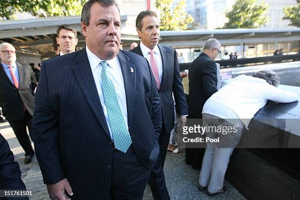 New Jersey Gov. Chris Christie and New York Gov. Andrew Cuomo walk after seeing Hector Garcia as he watches over his wife Carmen as she hugs the...