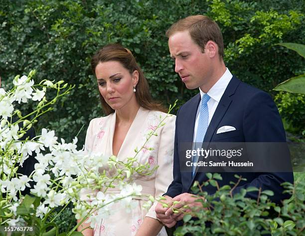 Catherine, Duchess of Cambridge and Prince William, Duke of Cambridge look on at an orchid named in honour of Diana, Princess of Wales at Singapore...