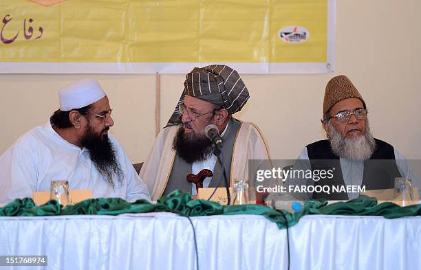 Pakistani Islamist groups and Defence of Pakistan coalition leaders Hafiz Muhammad Saeed chats with Maulana Sami ul Haq as Syed Munawar Hasan looks...