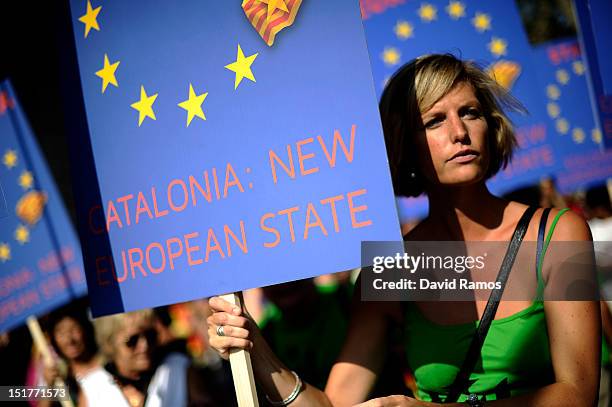 Woman holds a banner that it reads 'Catalonia: New European State' during a demonstratacion calling for independence during the Catalonia's National...