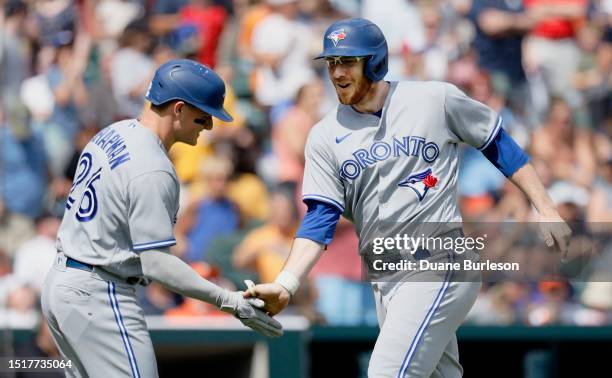 Danny Jansen of the Toronto Blue Jays celebrates his two-run home run against the Detroit Tigers with Matt Chapman during the ninth inning at...