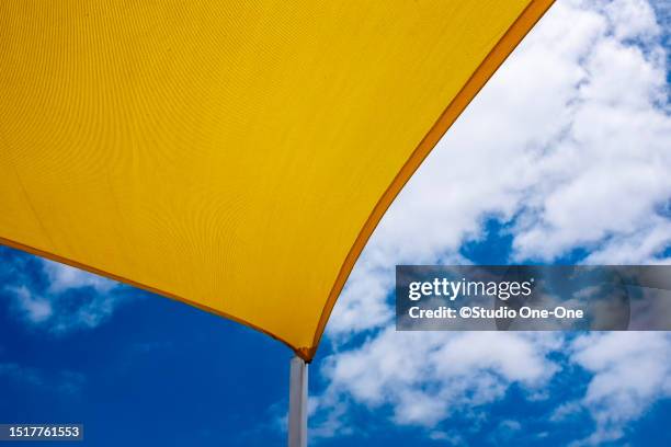 yellow shade sail - shade sail stock pictures, royalty-free photos & images