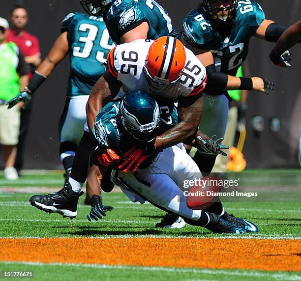 Running back LeSean McCoy of the Philadelphia Eagles fumbles the football after being hit by linebacker Juqua Parker of the Cleveland Browns during a...