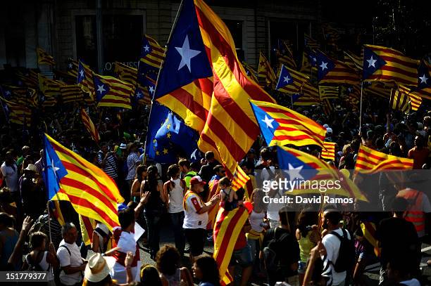 People hold Pro-independence Catalan flags in a demonstration calling for independence during the Catalonia's National Day on September 11, 2012 in...