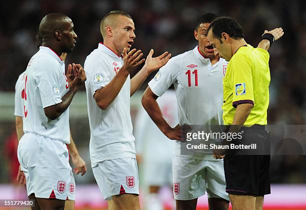 Jermain Defoe, Tom Cleverley and Alex Oxlade-Chamberlain of England protest to referee Cuneyt Cakir as Defoe's goal is disallowed during the FIFA...