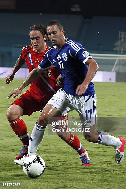 Israel’s forward Ben Sahar vies for the ball with Russia's defender Andrei Yeschenko during his team's FIFA 2014 World Cup qualifying group F match...