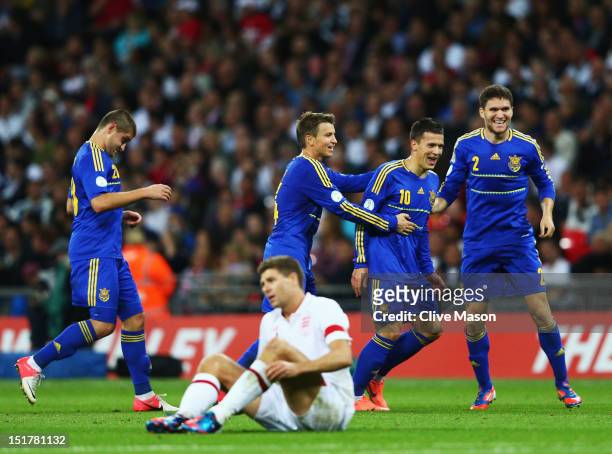 Steven Gerrard of England looks dejected as Yevhen Konoplianka of Ukraine celebrates wcoring their first goal during the FIFA 2014 World Cup Group H...