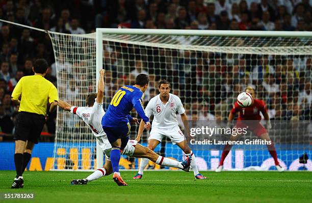 Yevhen Konoplianka of Ukraine shoots past Steven Gerrard of England to score their first goal with during the FIFA 2014 World Cup Group H qualifying...