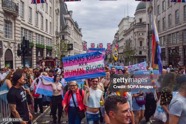 Protester holds a 'Trans rights are human rights' placard during the demonstration in Piccadilly Circus. Thousands of people marched through central...