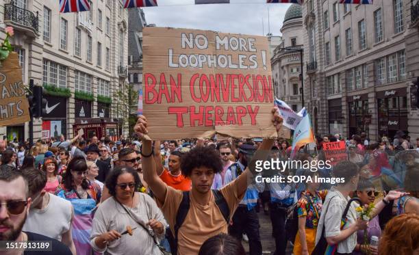 Protester holds a placard calling for a ban on conversion therapy during the demonstration in Piccadilly Circus. Thousands of people marched through...