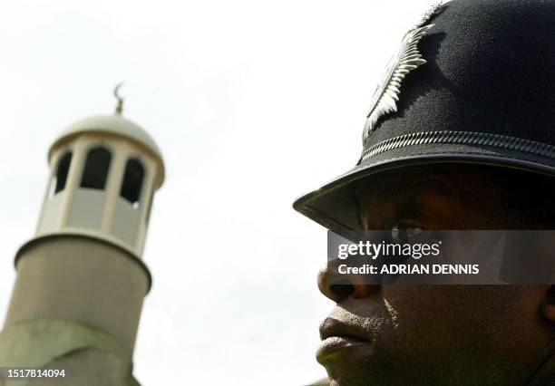 Metropolitan Police stands outside Finsbury Park mosque as radical cleric Abu Hamza al Masri delivers his prayer in north London 16 April 2004....