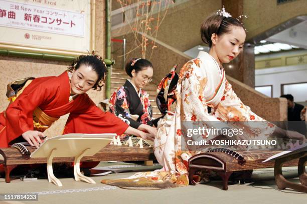 Female harpists in colorful kimono dresses play koto or Japanese long harps to celebrate New Year at a Tokyo department store 03 January 2005. The...