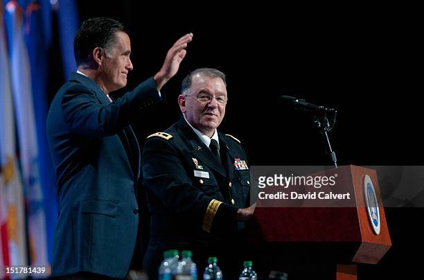 Republican presidential candidate, former Massachusetts Gov. Mitt Romney waves after addressing the crowd with Maj. Gen. Francis D. Vavala at the...