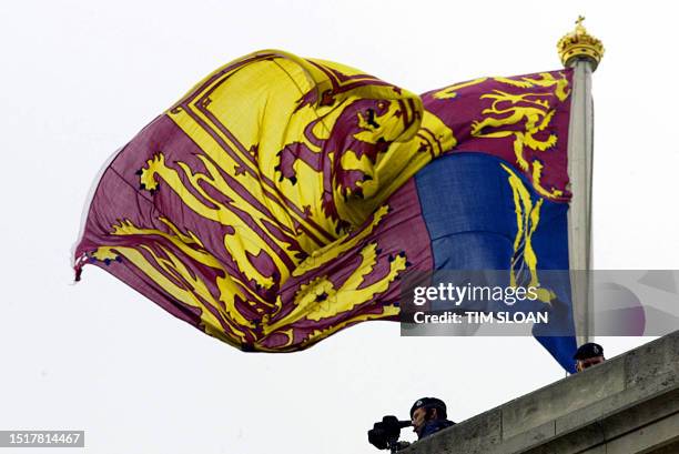 Sercurity personel stand guard on the Palace roof just below the Queen's flag during the full State arrival ceremony for US President George W. Bush...