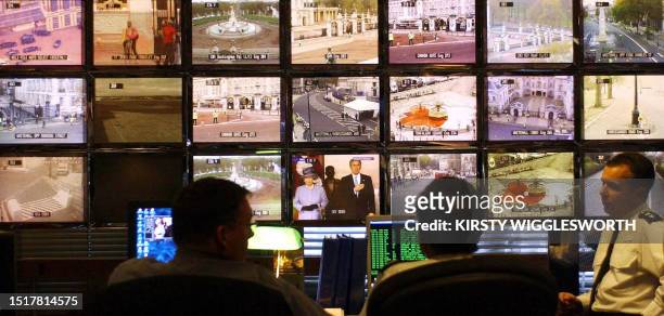 Officers directing the massive security operation surrounding the State Visit by US President Bush watch over monitors showing CCTV and news images...