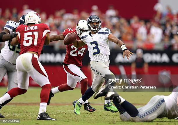 Quarterback Russell Wilson of the Seattle Seahawks throws a pass against the Arizona Cardinals during the season opener at the University of Phoenix...