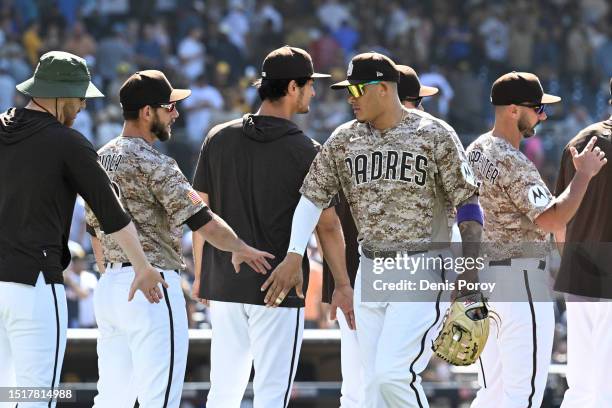 Manny Machado of the San Diego Padres and teammates celebrate with high-fives after the Padres defeated the New York Mets 6-2 in a baseball game July...