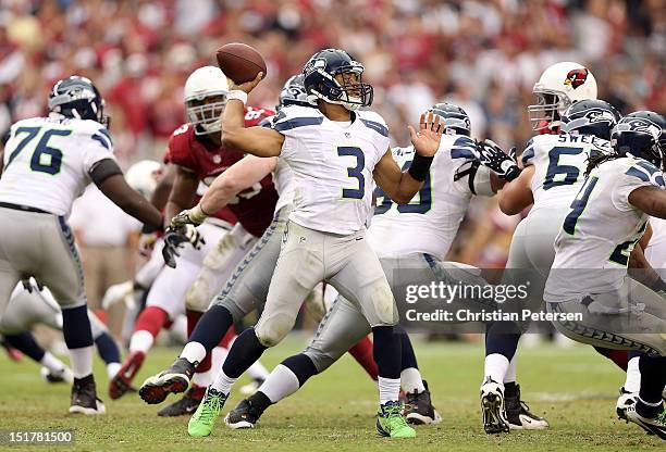 Quarterback Russell Wilson of the Seattle Seahawks throws a pass against the Arizona Cardinals during the season opener at the University of Phoenix...