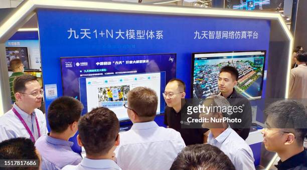 Visitors visit the China Mobile booth at the 2023 World Artificial Intelligence Conference in Shanghai, China, July 7, 2023. In addition to 5G...